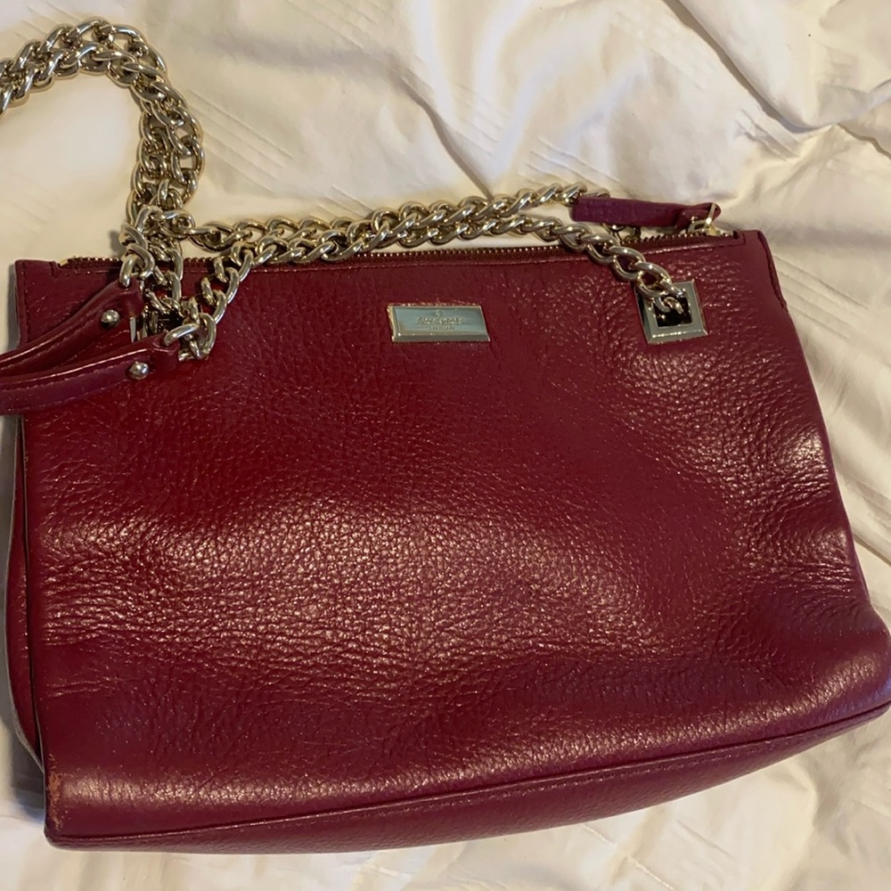 Beautiful cranberry Kate Spade bag with pockets new without tags. Brass straps